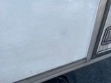 an image of a white truck with a door open