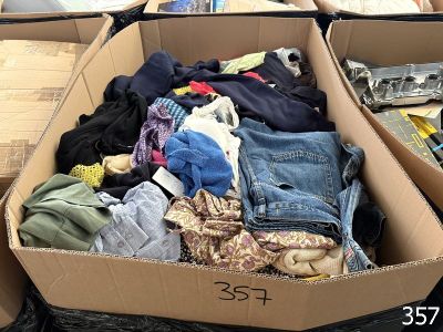 a cardboard box filled with clothes and other items