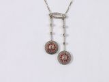a close up of a necklace on a white surface with a white background