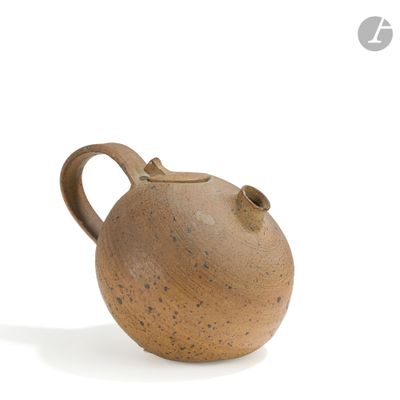 a brown vase that is sitting on a white surface