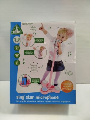 a box with a picture of a little girl singing on a microphone