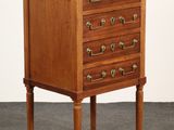 an image of a small wooden chest of drawers with a marble top