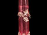 a red glass vase with a butterfly decoration on it