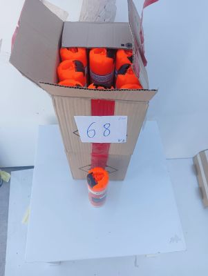 a cardboard box filled with oranges on a white table