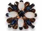 an image of a broochle with oplite and sapphires
