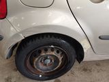 a car that has a flat tire on the side of the road