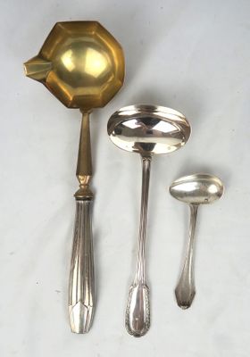 four spoons and a ladle on a table
