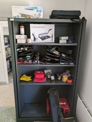 a black bookcase with many items on top of it