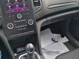 someone is sitting in the driver ' s seat of a car with a remote control