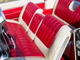 an image of a red and white car with leather seats
