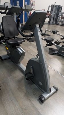 a row of stationary exercise bikes in a gym