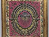 painting of a flower in a gold frame on a pink background