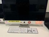 a computer monitor and keyboard on a desk