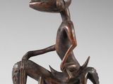 an image of a wooden sculpture of a woman sitting on a horse