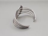 a close up of a silver ring on a white surface