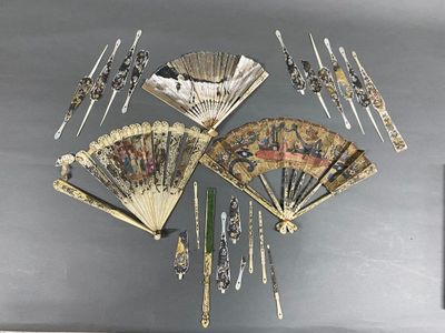 many different types of hand fans hanging on the wall