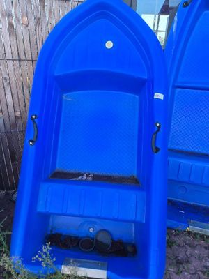 two blue plastic boats sitting next to each other on the ground