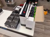 many electronic devices on a table in a store