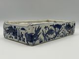 an image of a blue and white rectangular dish with flowers and birds