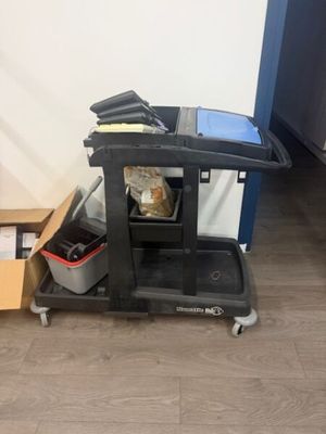a black cart with a box on the floor next to it