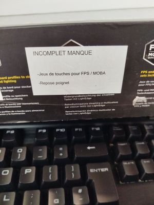 a computer keyboard with a box on top of it