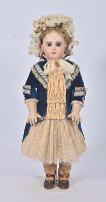 an antique doll of a woman in a blue dress and hat