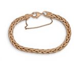 a close up of a gold bracelet on a white background