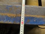 a measuring tape on a piece of metal that is being used to measure the height of a piece of metal