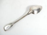 a silver spoon with a spoon handle on a white surface