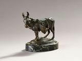 bronze statue of a bull on a marble base on a white background