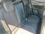 the back seats of a car with a bottle of soda in it