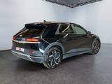 the rear end of a black volkswagen suv parked in a garage