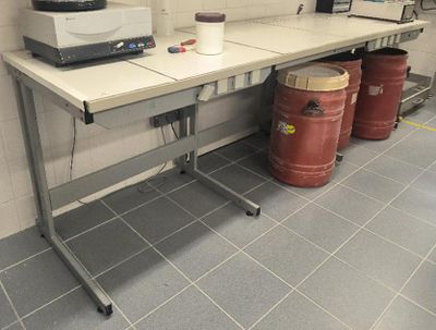 an image of a kitchen with a table and two barrels