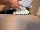 a person that is opening a box with a bunch of cigarettes