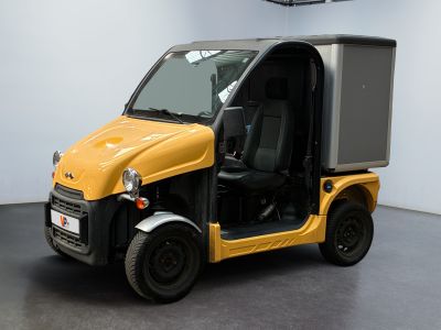 a small yellow vehicle with a black roof and door open