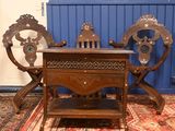 a wooden table and chairs in a room with blue walls