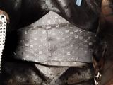 a close up of a black tie with a silver chain around it