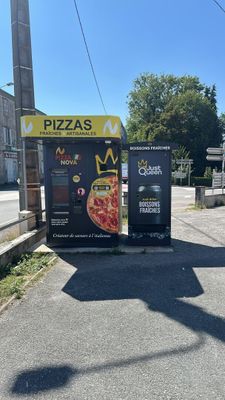 two vending machines sitting on the side of the road