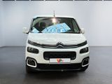 the front of a white citrole parked in a showroom