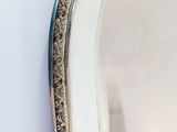 a close up of a mirror on a wall next to a white wall