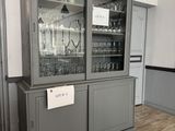a cabinet with a glass door and a sign on it