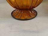 a large orange glass bowl sitting on top of a table