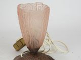 a pink glass lamp that is sitting on a table