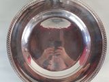 a person taking a picture in a mirror of a silver plate