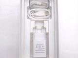 a white box with a charger and a cable in it