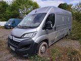 the van is parked on the side of the road in the grass