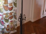 a lamp that is on a stand in front of a curtain