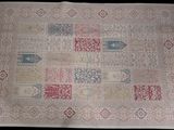 an antique rug with a patchwork design and fringes
