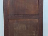 a wooden cabinet that is on the floor in the room
