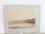 an old photo of a bridge over a river with a castle in the background